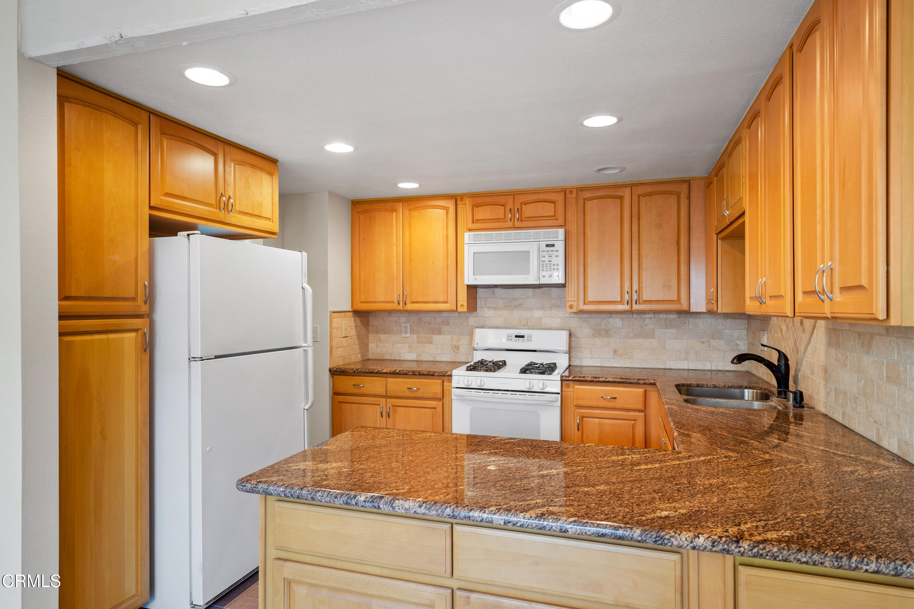 500 Holly Avenue Oxnard, CA 93036 - Photo 14 of 33 a kitchen with stainless steel appliances granite countertop a refrigerator a stove and a sink with wooden floor