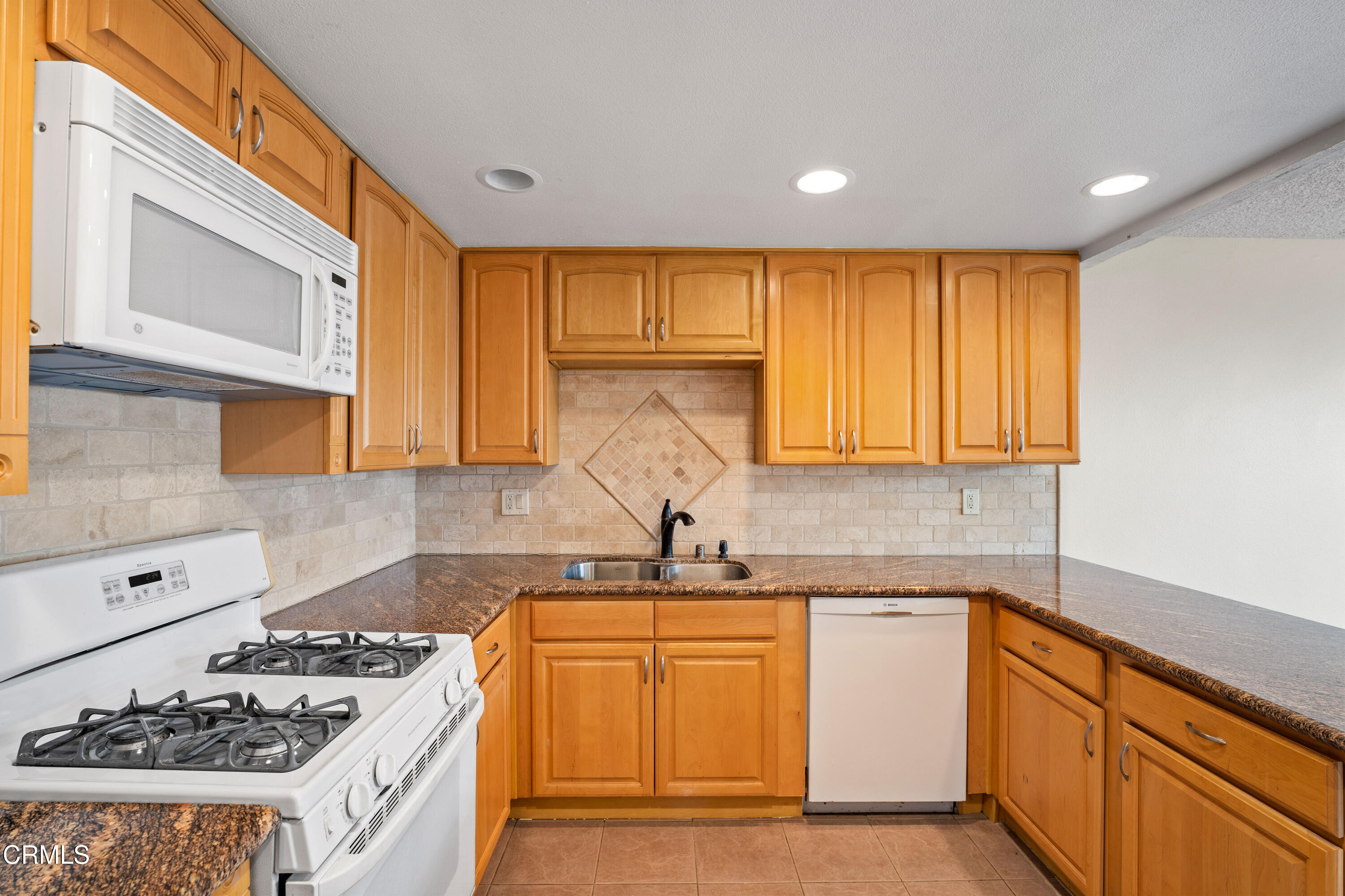 500 Holly Avenue Oxnard, CA 93036 - Photo 16 of 33 a kitchen with a sink stove top oven and cabinets