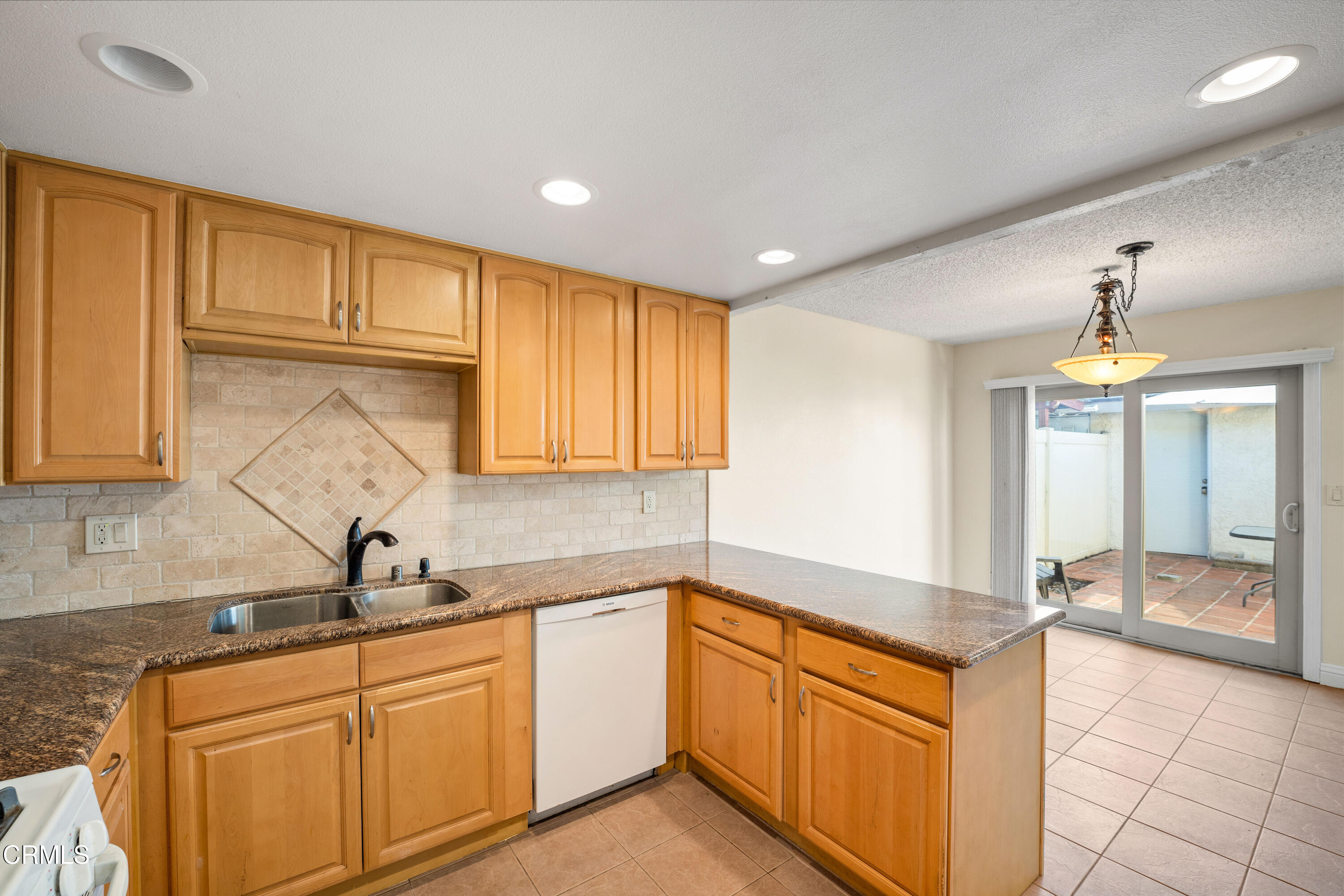 500 Holly Avenue Oxnard, CA 93036 - Photo 17 of 33 a kitchen with granite countertop a sink and cabinets