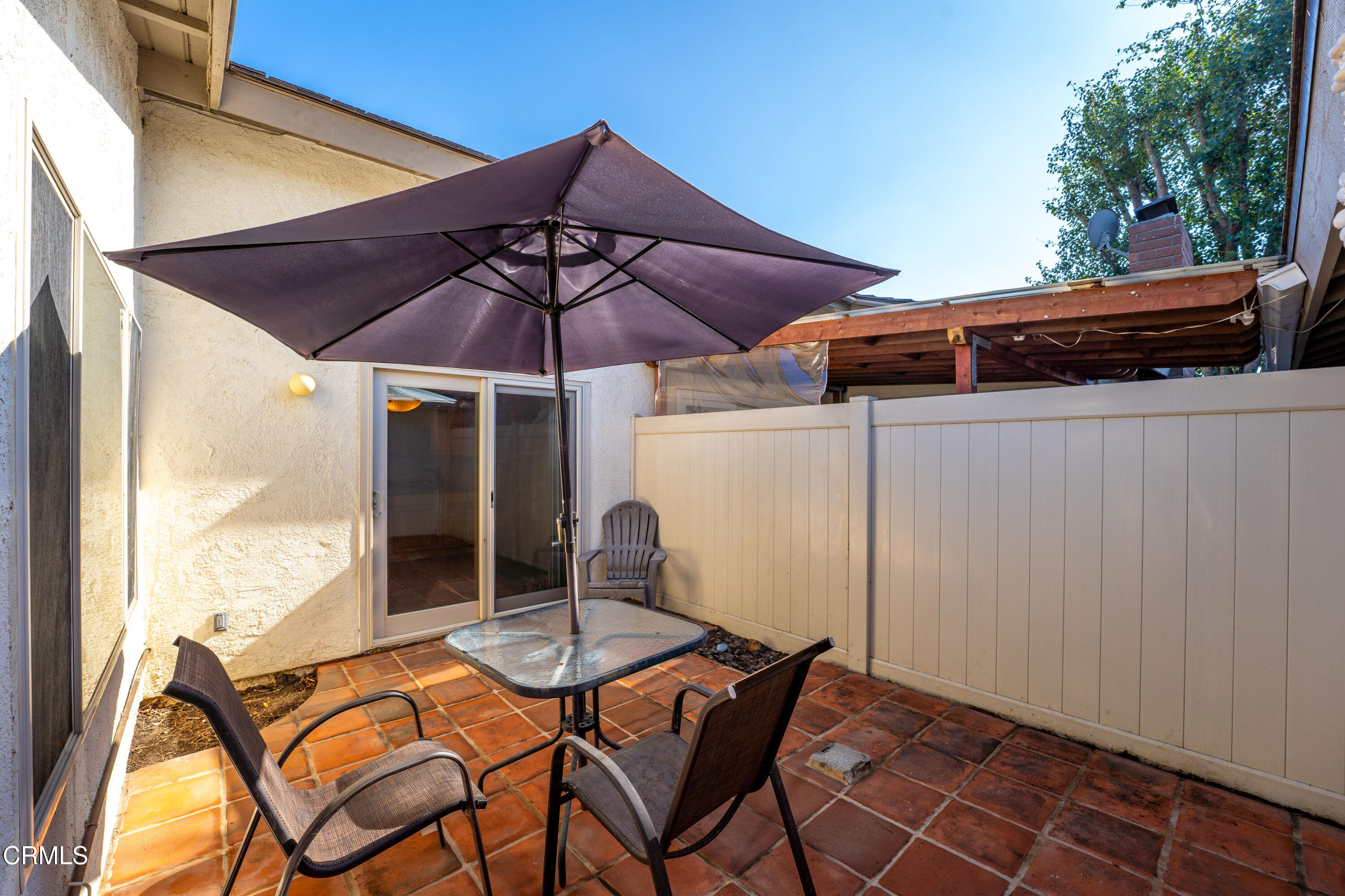500 Holly Avenue Oxnard, CA 93036 - Photo 27 of 33 a patio with a table and chairs under an umbrella