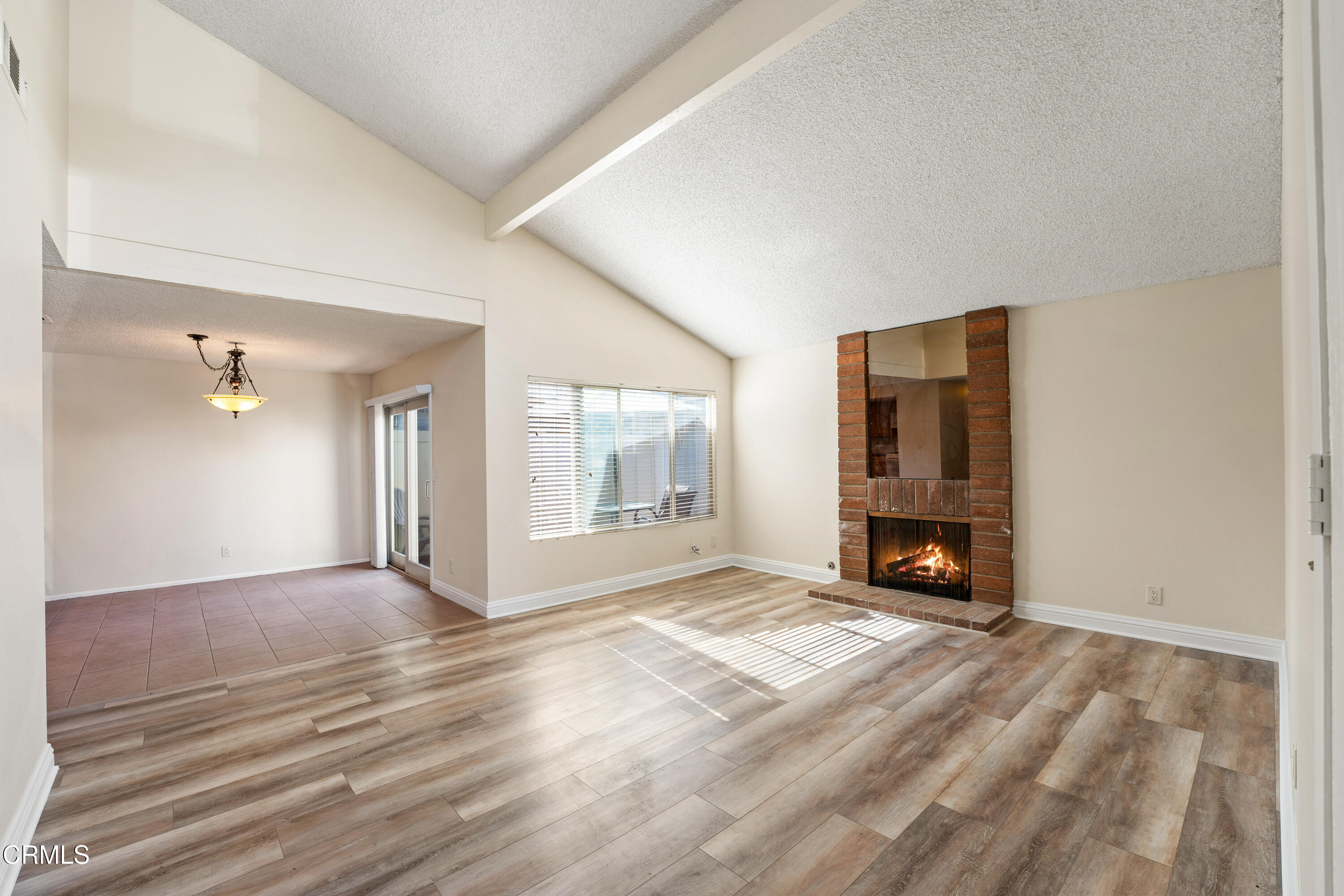 500 Holly Avenue Oxnard, CA 93036 - Photo 3 of 33 a view of an empty room with a fireplace and a window