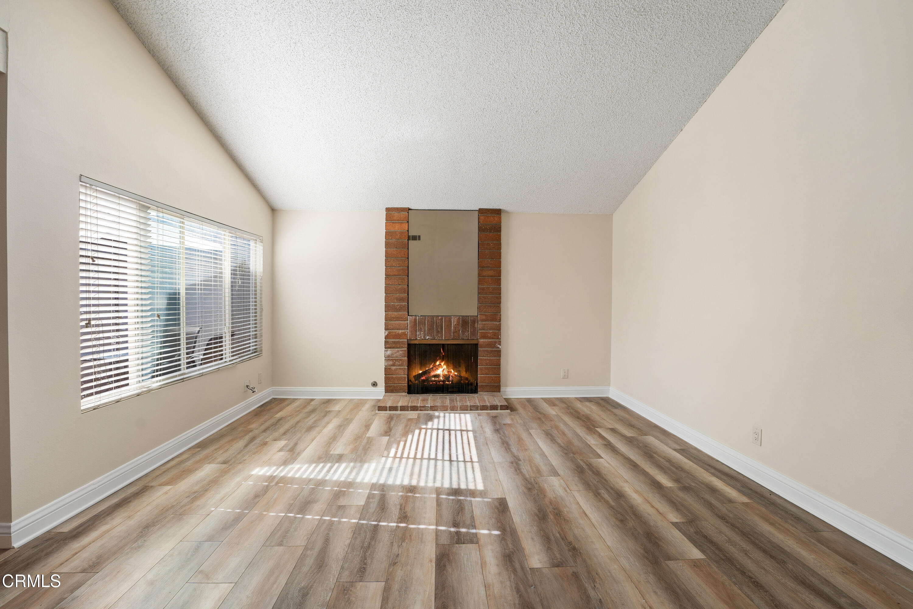 500 Holly Avenue Oxnard, CA 93036 - Photo 8 of 33 a view of an empty room with wooden floor fireplace and a window