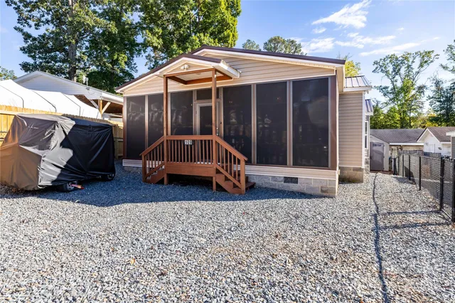 a view of a house with a yard and sitting area