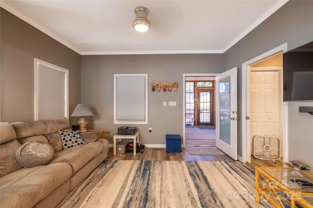 a living room with furniture and a floor to ceiling window