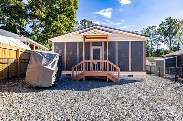 a view of a house with a yard and sitting area