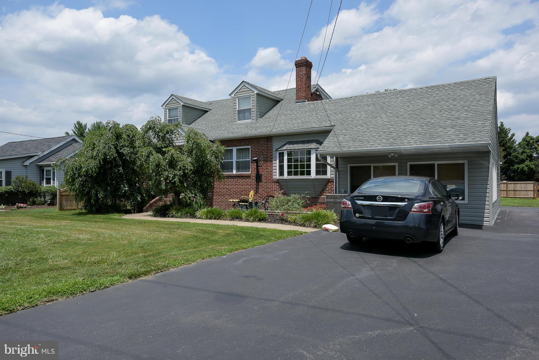 636 Deale Road Deale, MD 20751 - Photo 2 of 30 a car parked in front of a brick house