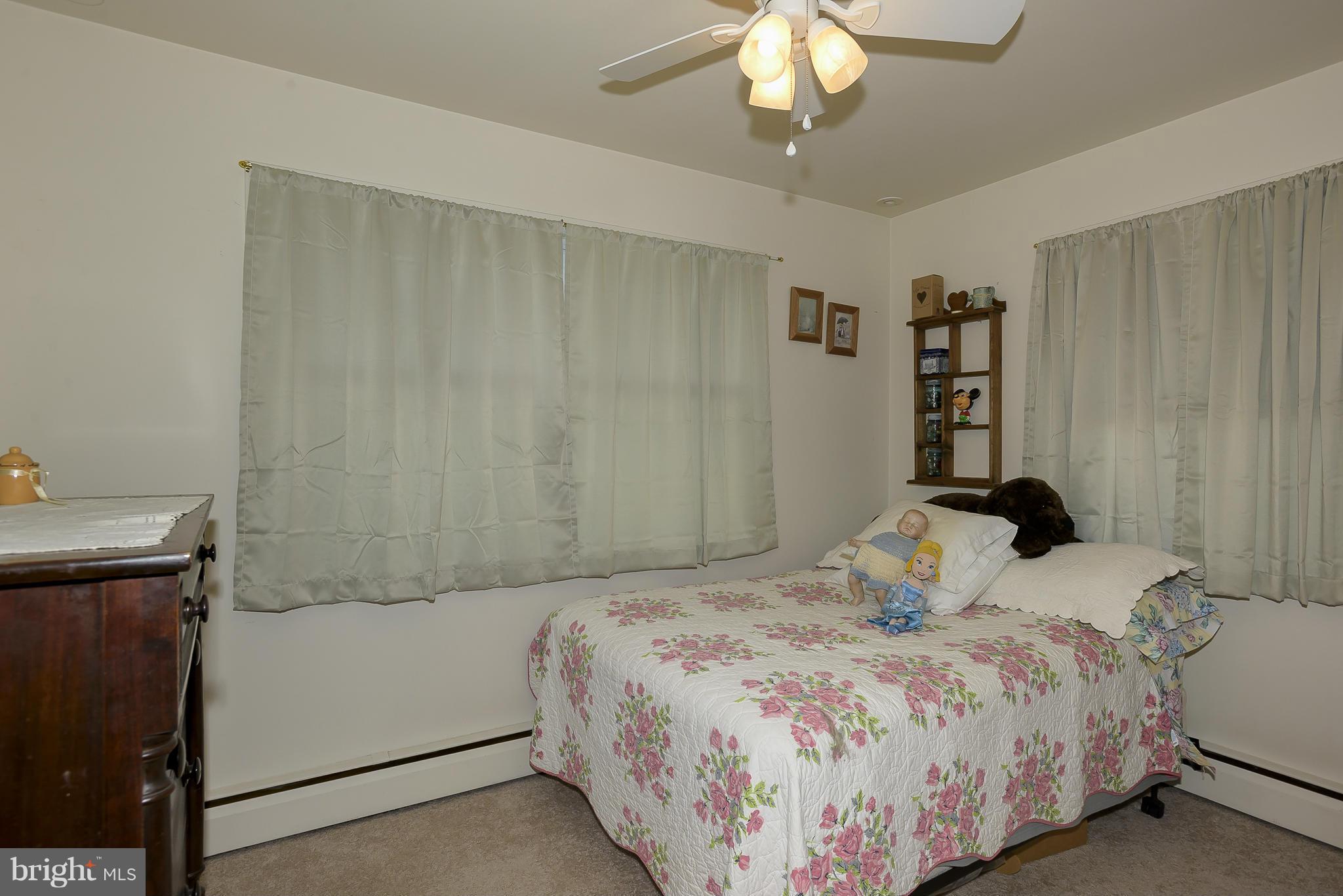 636 Deale Road Deale, MD 20751 - Photo 13 of 30 a bedroom with a bed and a chandelier
