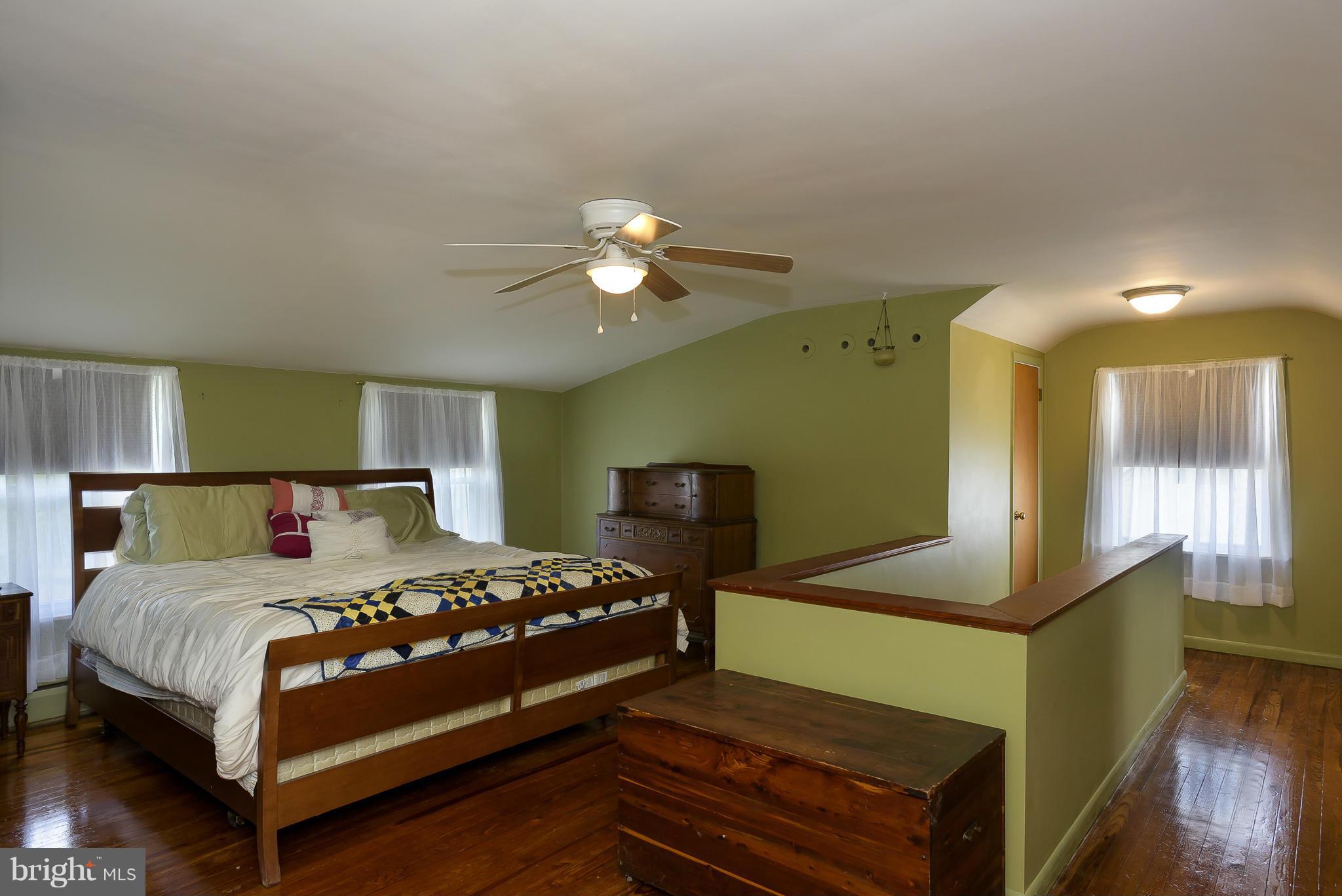 636 Deale Road Deale, MD 20751 - Photo 15 of 30 a bedroom with a bed and a chandelier