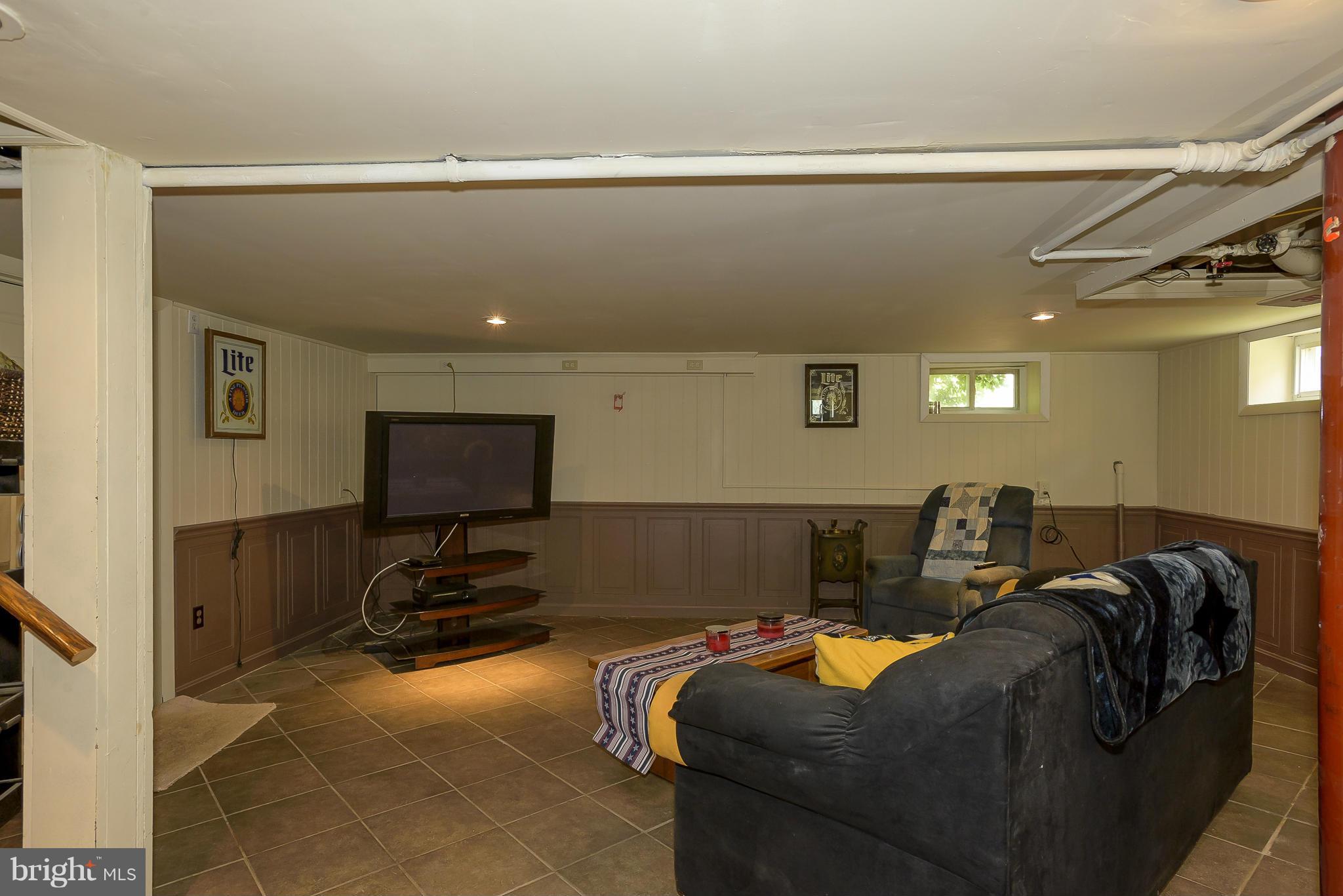 636 Deale Road Deale, MD 20751 - Photo 19 of 30 a living room with furniture and a projector screen