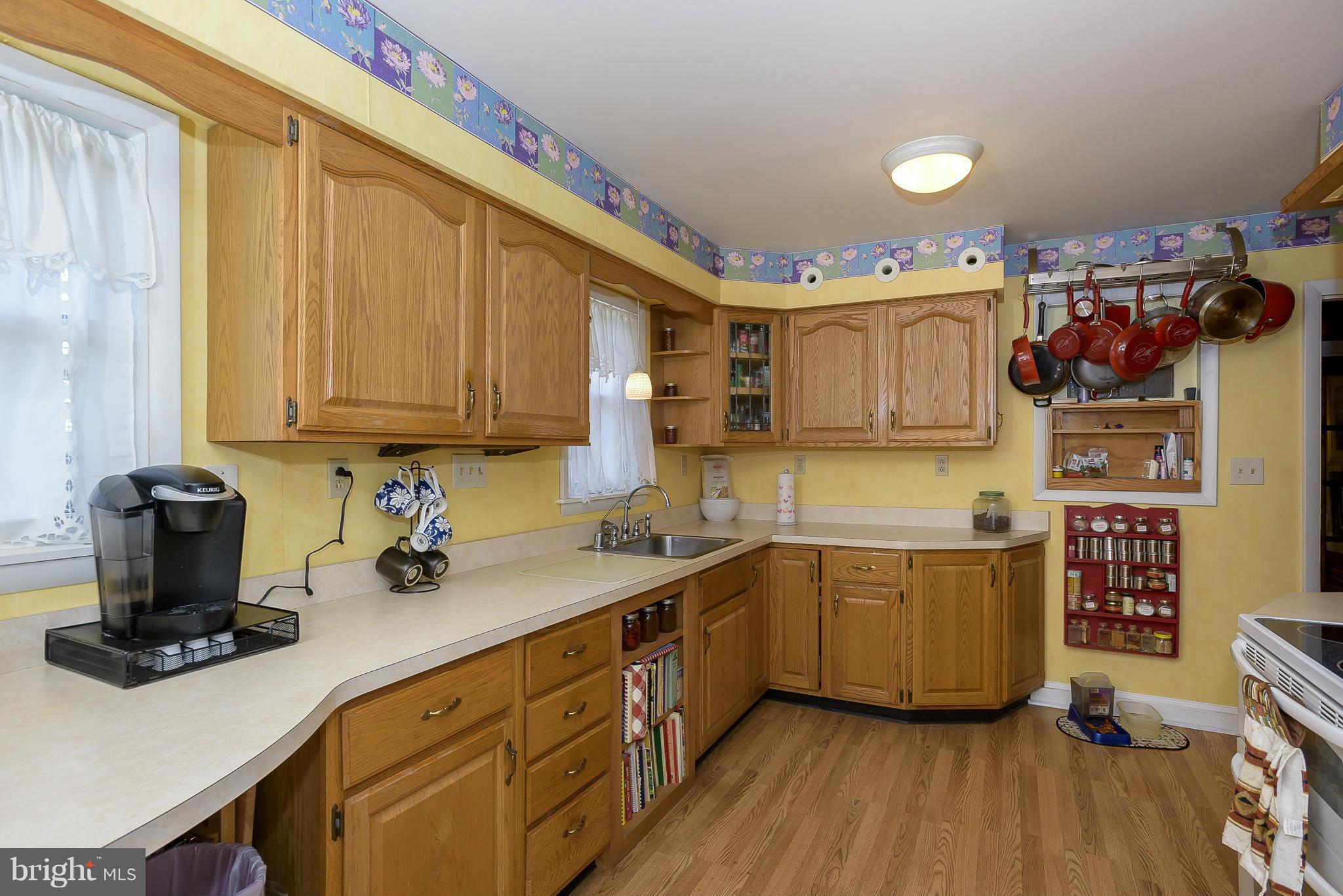 636 Deale Road Deale, MD 20751 - Photo 8 of 30 a kitchen with stainless steel appliances a sink cabinets and wooden floor
