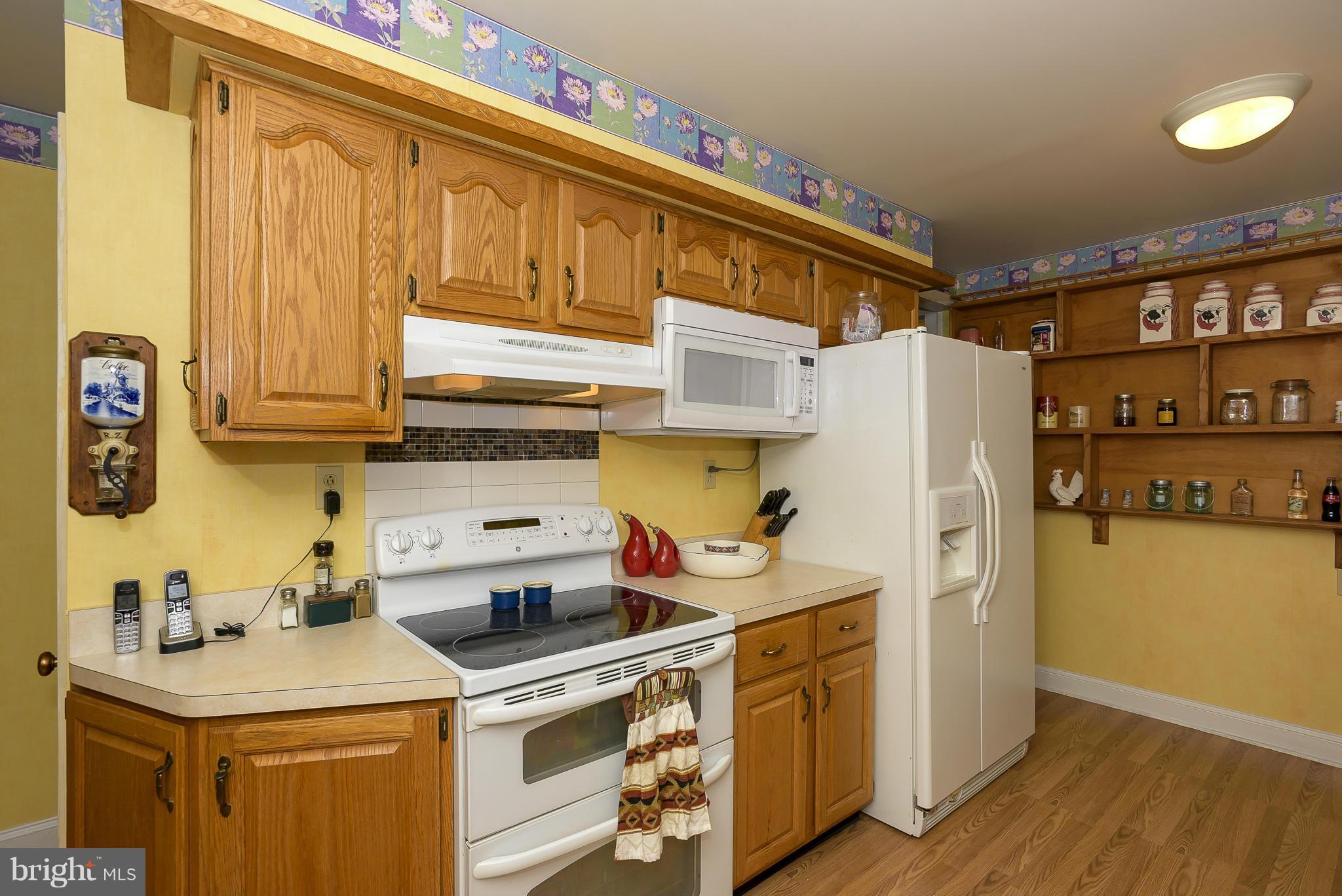 636 Deale Road Deale, MD 20751 - Photo 9 of 30 a kitchen with stainless steel appliances a stove a refrigerator a sink and cabinets