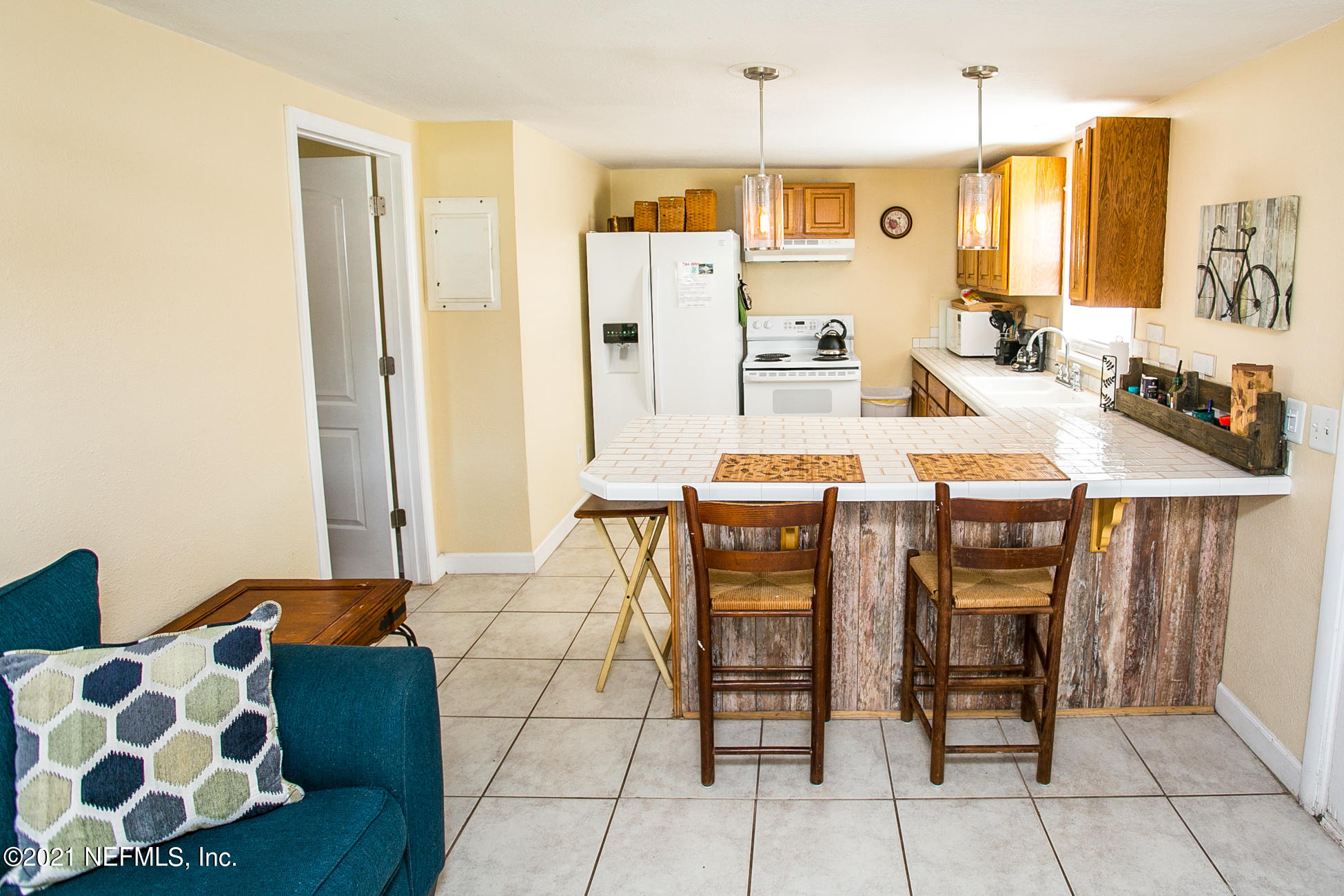 210 Palmetto Road St. Augustine, FL 32080 - Photo 13 of 16 a dining room with furniture and wooden floor