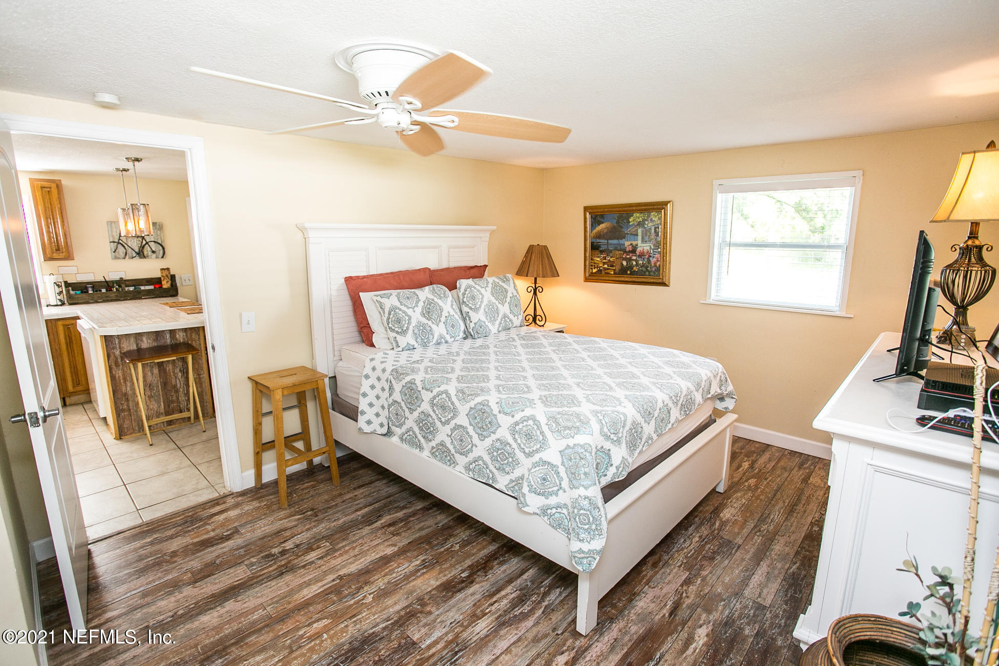 210 Palmetto Road St. Augustine, FL 32080 - Photo 14 of 16 a bedroom with a bed and a flat tv screen on the dresser
