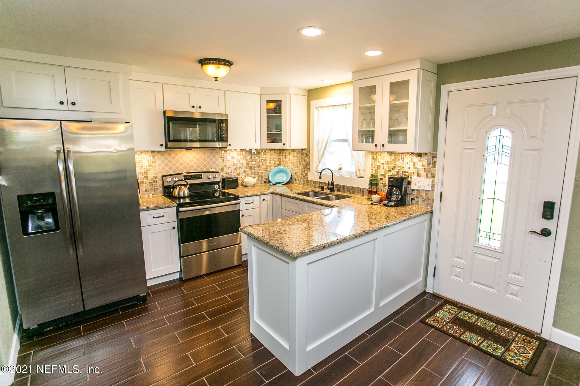 210 Palmetto Road St. Augustine, FL 32080 - Photo 3 of 16 a kitchen with stainless steel appliances granite countertop a refrigerator and a stove