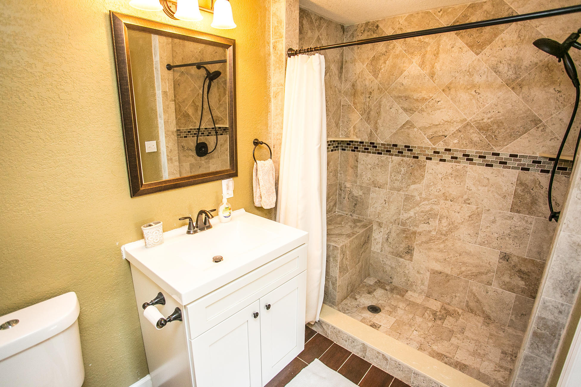 210 Palmetto Road St. Augustine, FL 32080 - Photo 8 of 16 a bathroom with a shower a sink and a mirror