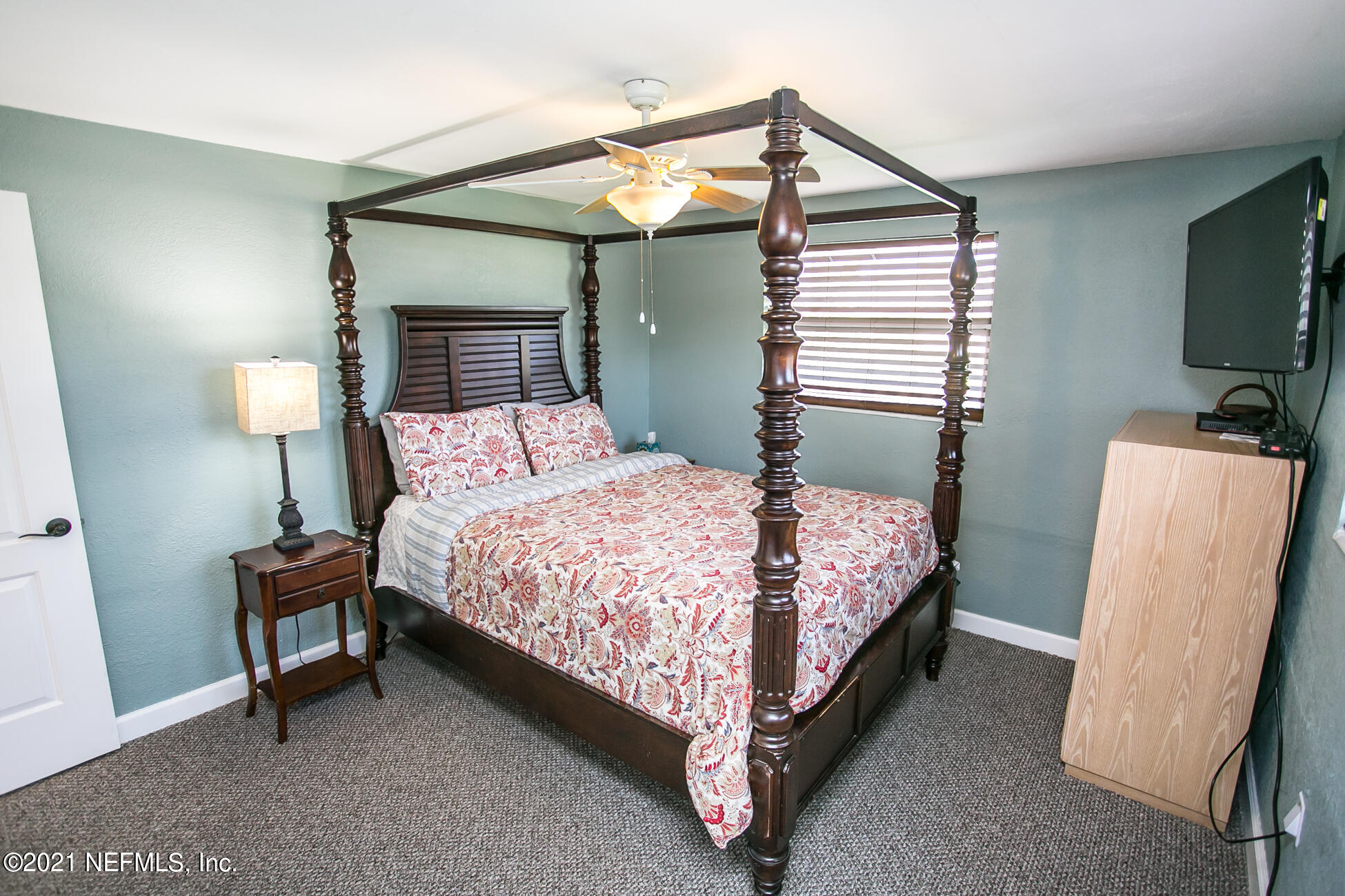 210 Palmetto Road St. Augustine, FL 32080 - Photo 9 of 16 a bedroom with a bed and a flat screen tv