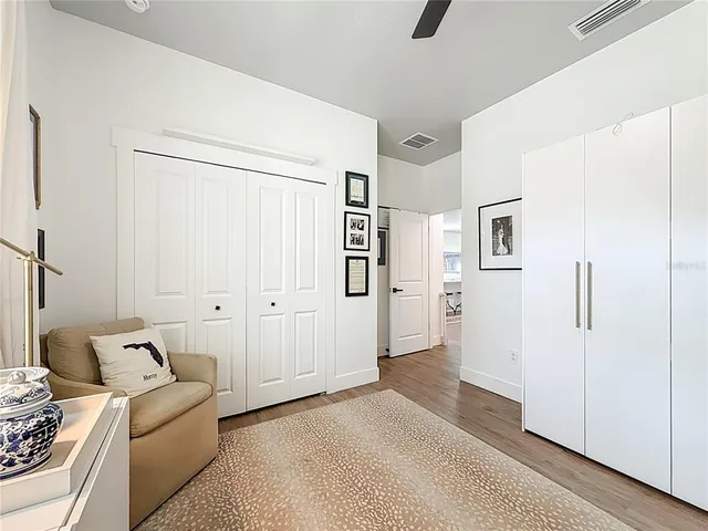 a bedroom with a bed a couch and a dresser