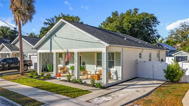 a view of a house with backyard porch and sitting area