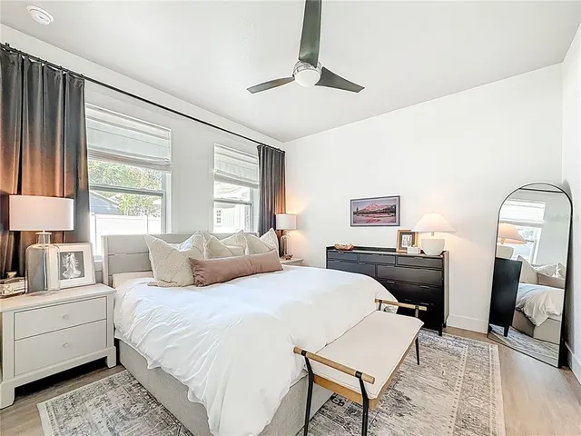 a bedroom with a large bed and a chandelier