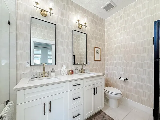 a view of a patio with a table and chairs and potted plants