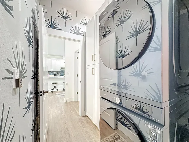 a view of a patio with table and chairs with wooden floor and fence