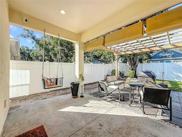 a building outdoor space with patio furniture and glass windows