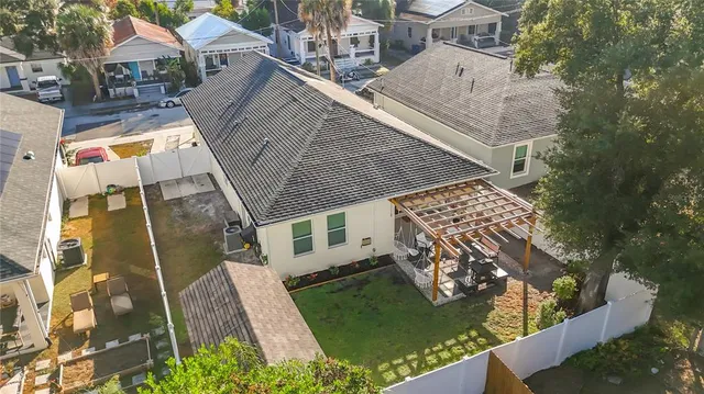 a view of a house with a big yard and large trees