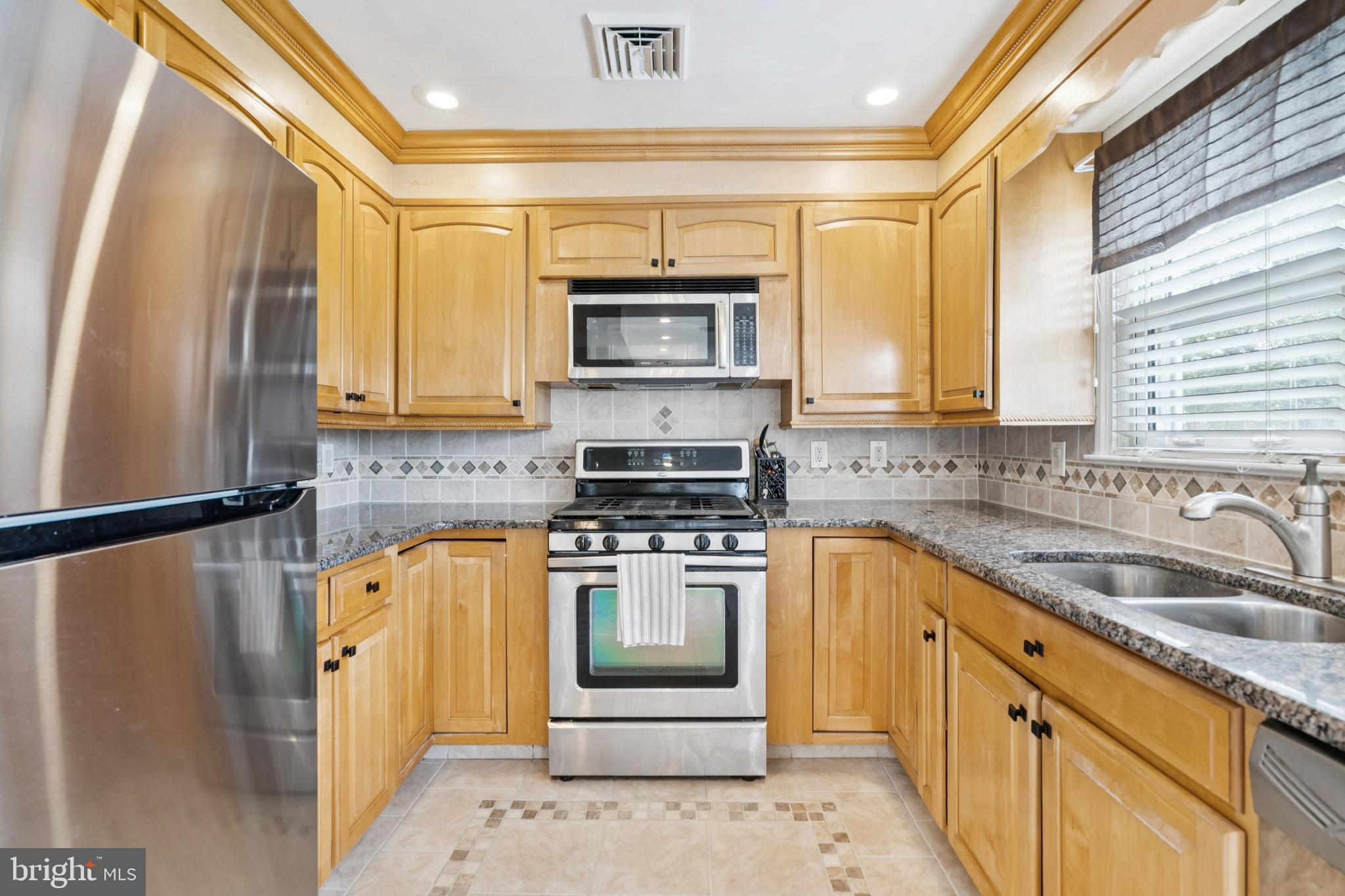 520 Rutgers Avenue Burlington, NJ 08016 - Photo 8 of 29 a kitchen with a sink stove and microwave