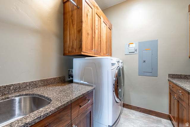 322 340 E Street Ivins, UT 84738 - Photo 45 of 61 Utility area featuring rich wood cabinetry, granite-finish countertops, stainless steel sink, and durable tile flooring