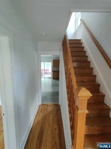 a view of entryway with wooden floor and stairs