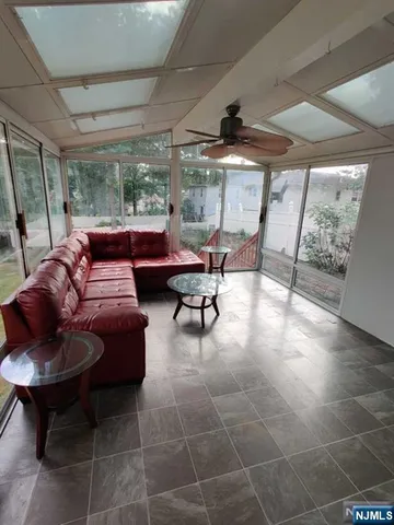 a living room with furniture and a large window