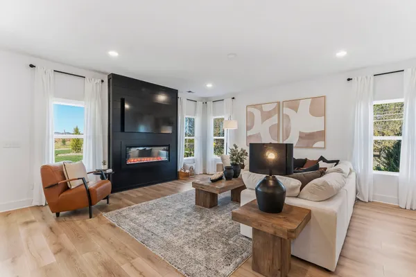 a living room with furniture a fireplace and a flat screen tv