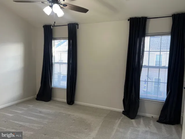 an empty room with windows and closet