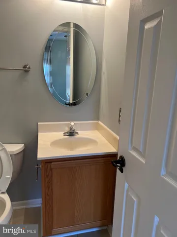 a bathroom with a sink toilet and mirror