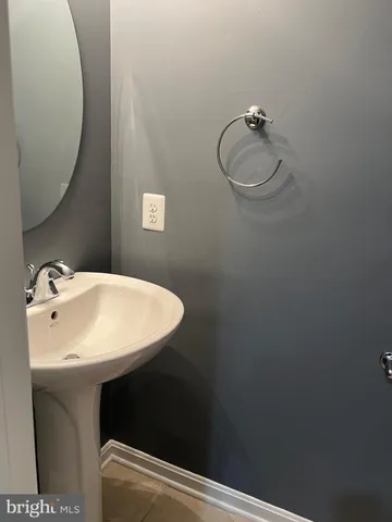 a bathroom with a sink mirror and vanity
