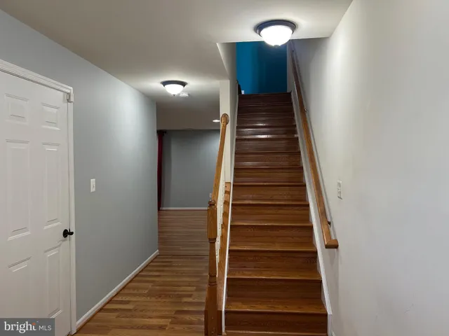 a view of entryway and hall with wooden floor
