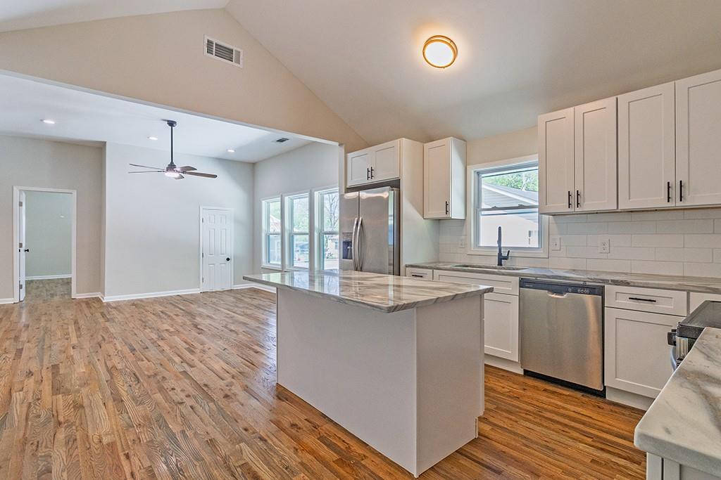 111 Ford Street Cartersville, GA 30120 - Photo 14 of 19 a kitchen with stainless steel appliances granite countertop a sink cabinets and wooden floor