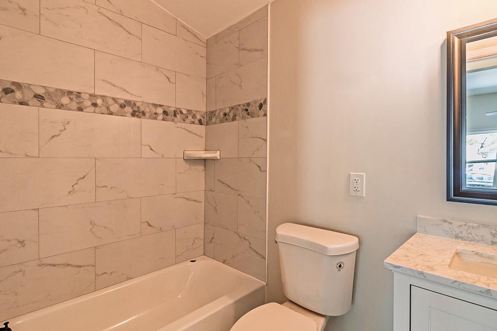 111 Ford Street Cartersville, GA 30120 - Photo 4 of 19 a bathroom with a toilet and a shower