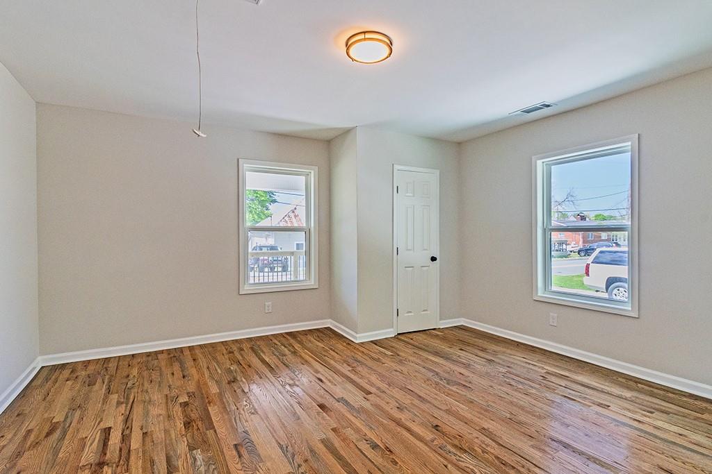 111 Ford Street Cartersville, GA 30120 - Photo 5 of 19 a view of empty room with window and wooden floor