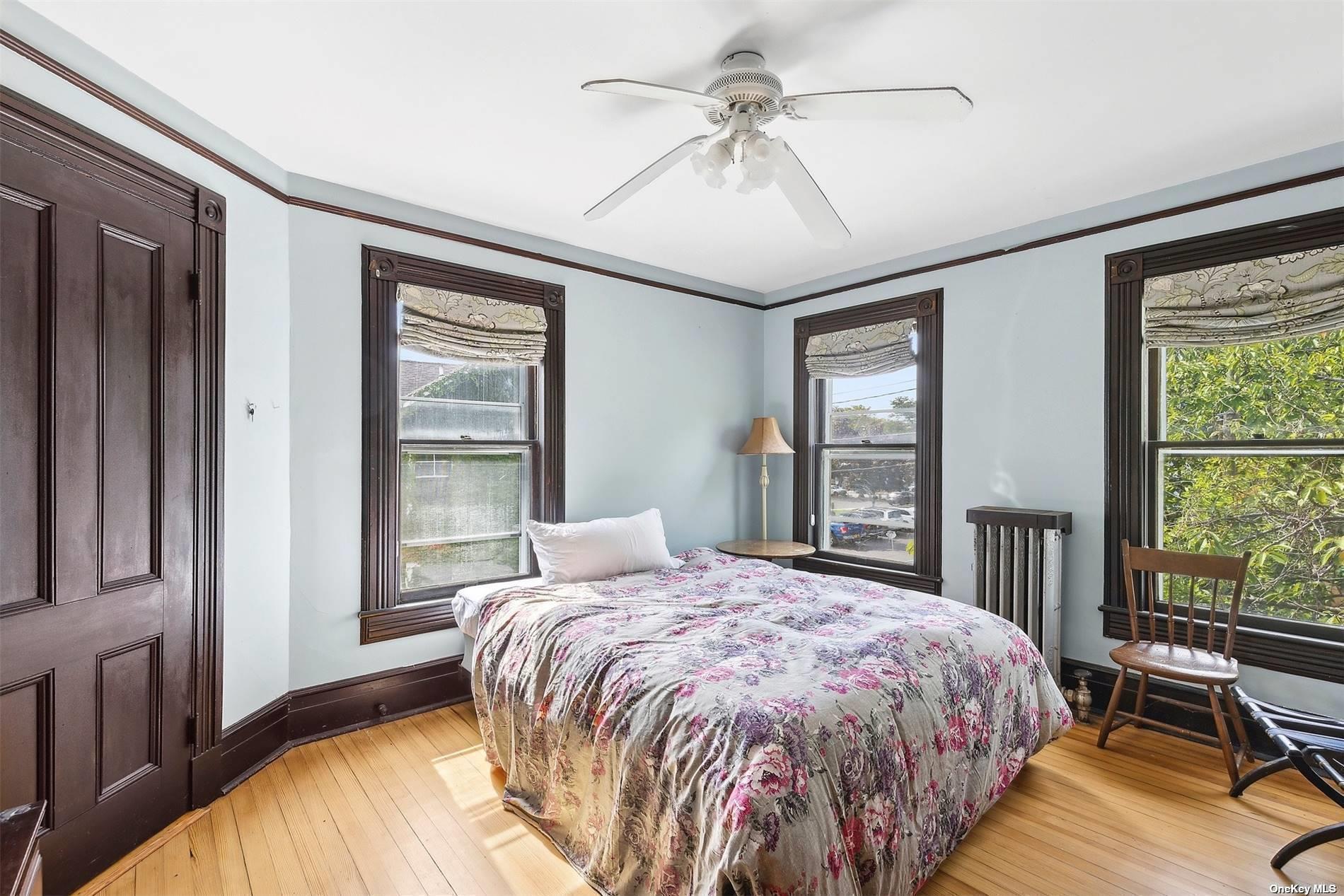 151 Bay Avenue Greenport, NY 11944 - Photo 11 of 21 a bedroom with a large bed and a large window