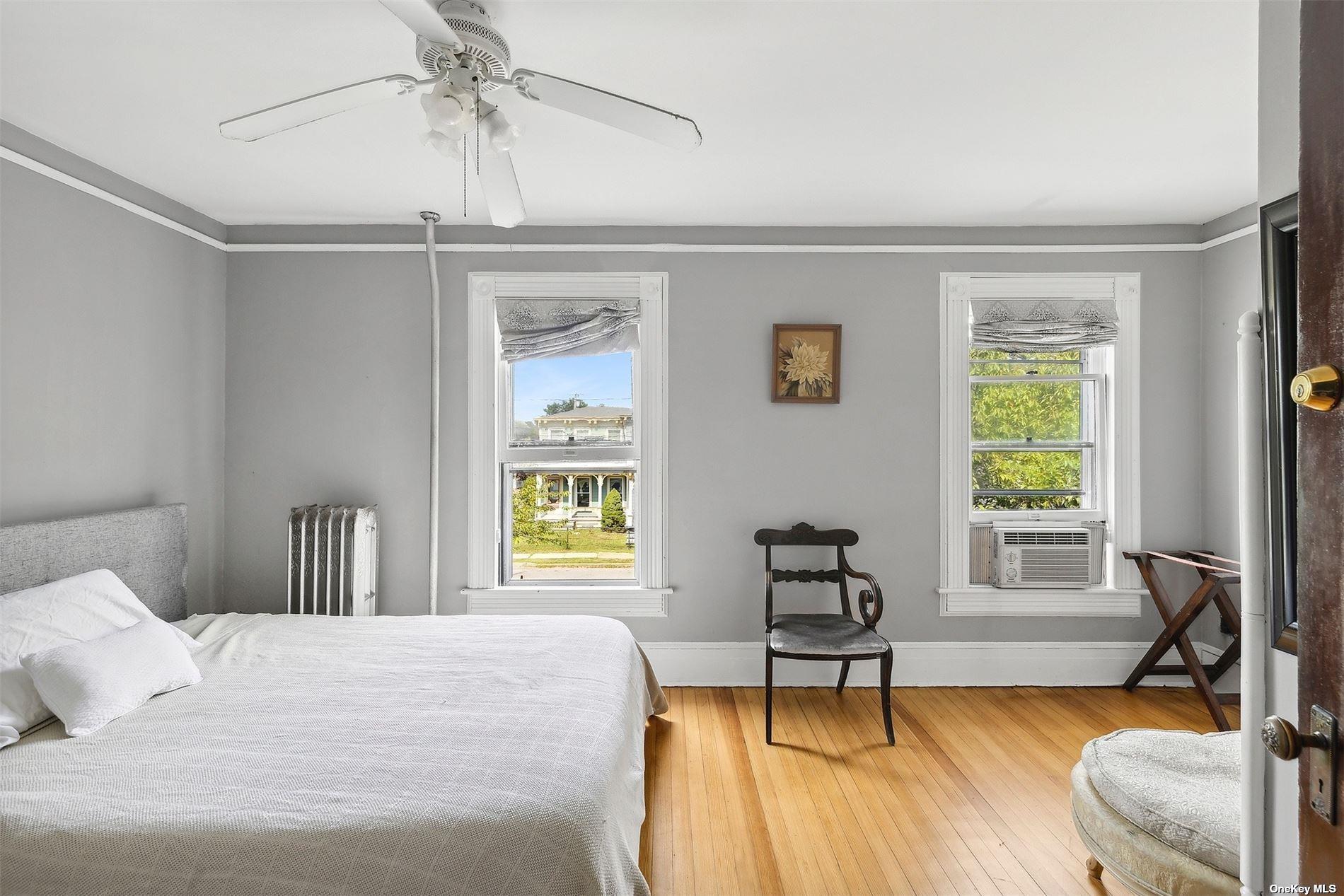 151 Bay Avenue Greenport, NY 11944 - Photo 12 of 21 a bedroom with a bed and a window