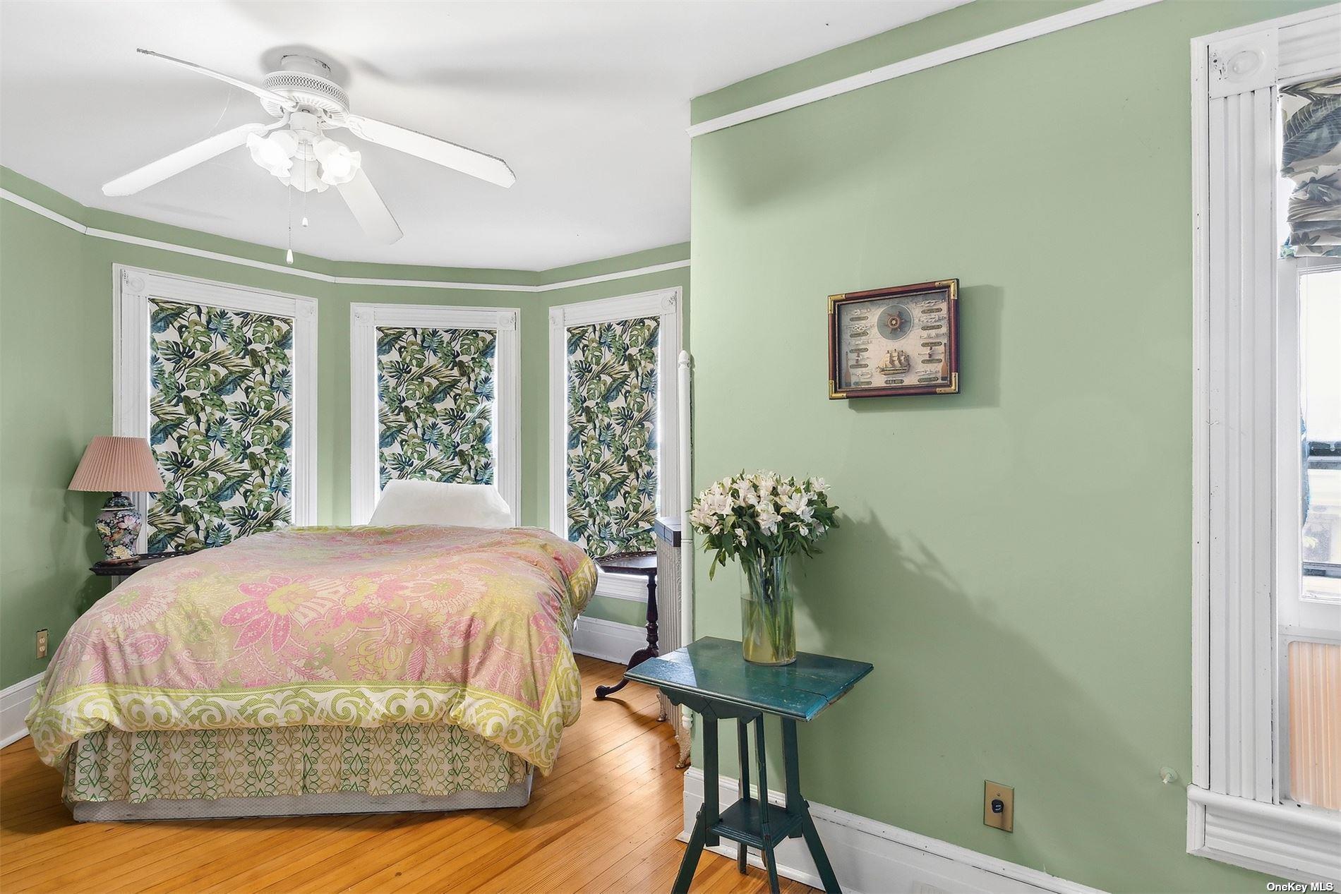 151 Bay Avenue Greenport, NY 11944 - Photo 13 of 21 a bedroom with a bed and a table in it with window