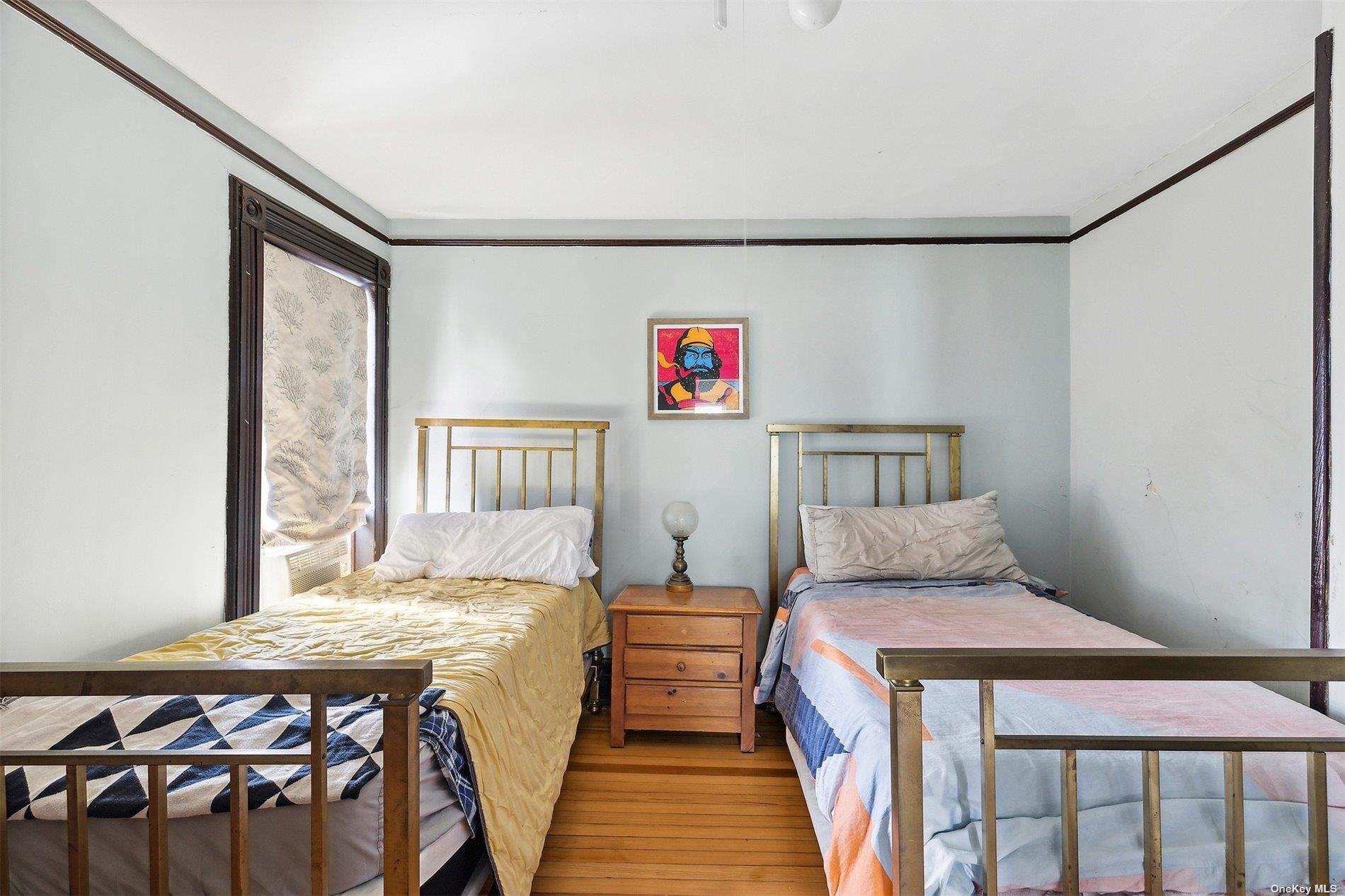 151 Bay Avenue Greenport, NY 11944 - Photo 14 of 21 a bedroom with a bed and wooden floor