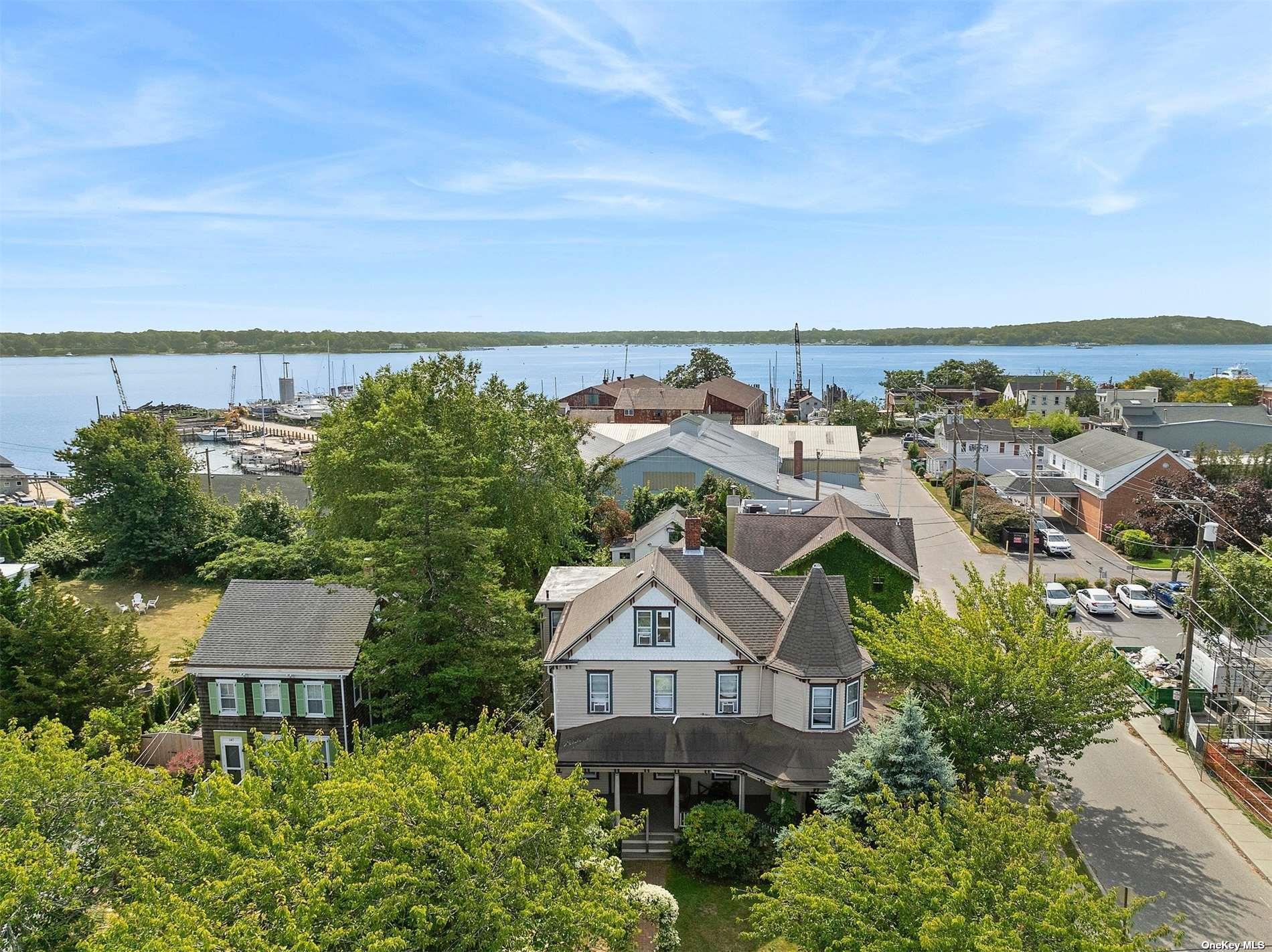 151 Bay Avenue Greenport, NY 11944 - Photo 15 of 21 an aerial view of a house with a garden and lake view