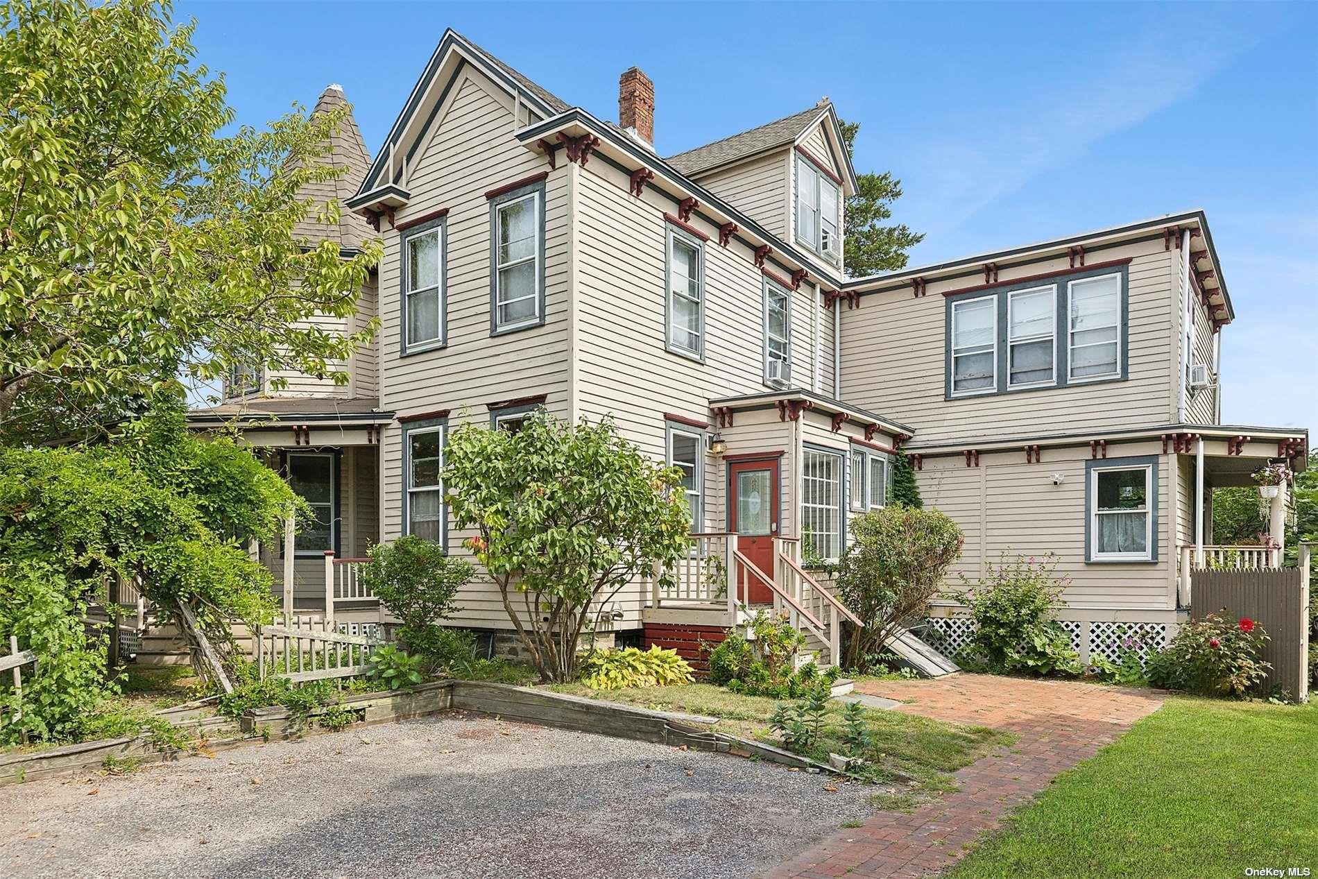 151 Bay Avenue Greenport, NY 11944 - Photo 2 of 21 a front view of a house with a garden