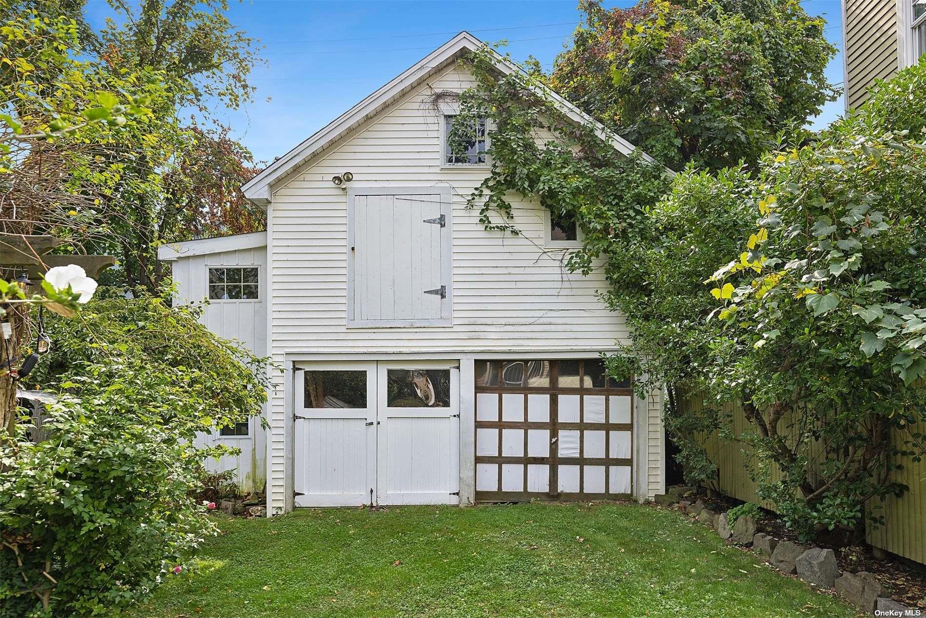 151 Bay Avenue Greenport, NY 11944 - Photo 3 of 21 a front view of a house with a garden