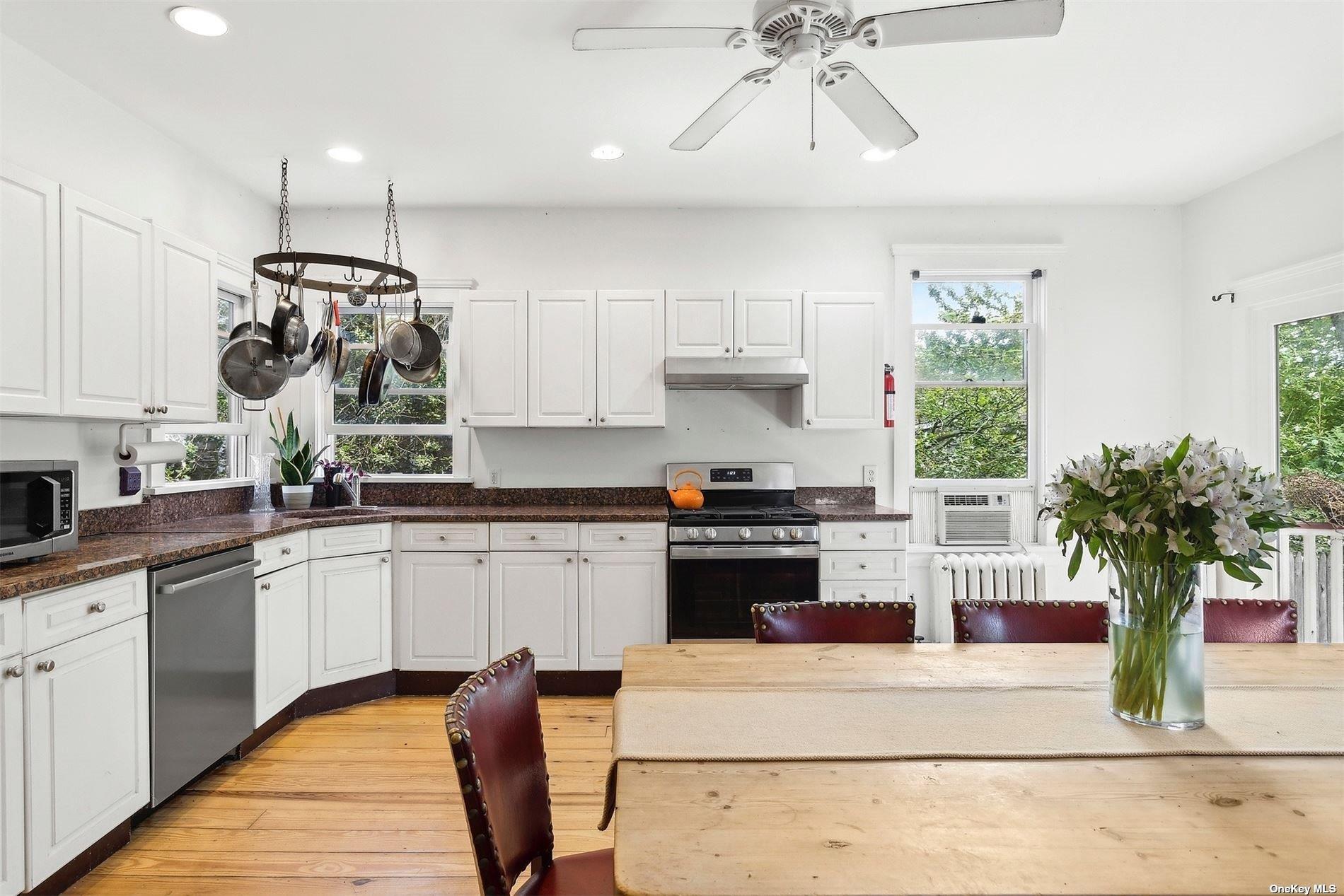 151 Bay Avenue Greenport, NY 11944 - Photo 4 of 21 a kitchen with a white stove top oven and white cabinets