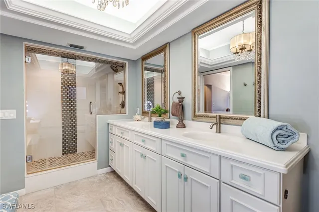 a spacious bathroom with a double vanity sink and mirror
