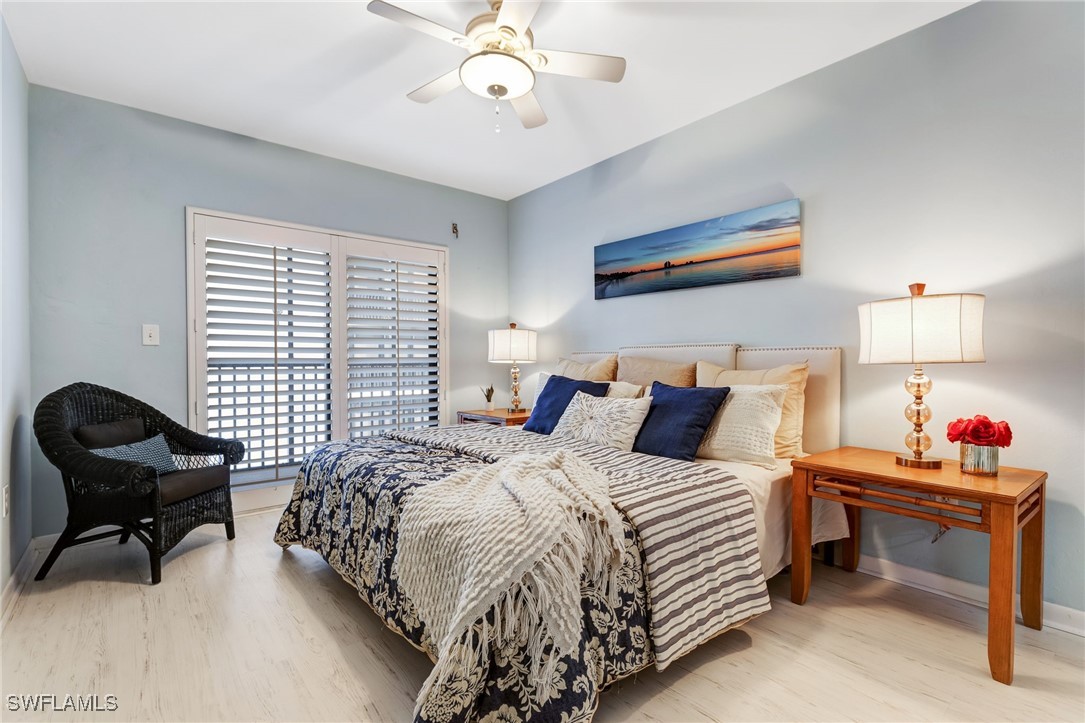 1910 Virginia Avenue, Unit 403 Fort Myers, FL 33901 - Photo 21 of 45 a bedroom with a bed and a chandelier