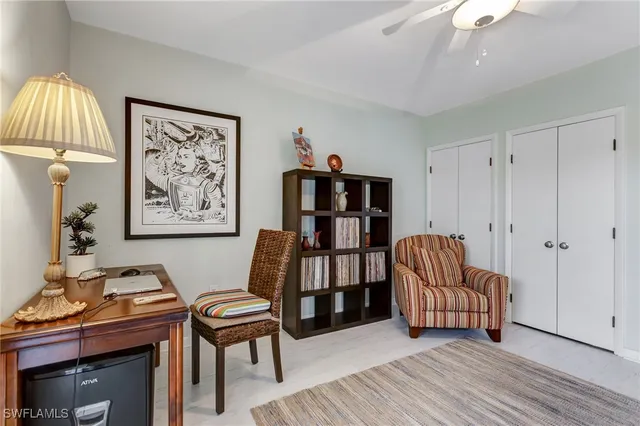 a living room with furniture and a baby crib